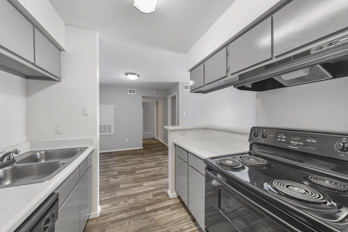 kitchen with stainless steel appliances and black cabinets at The Sonoma Apartments