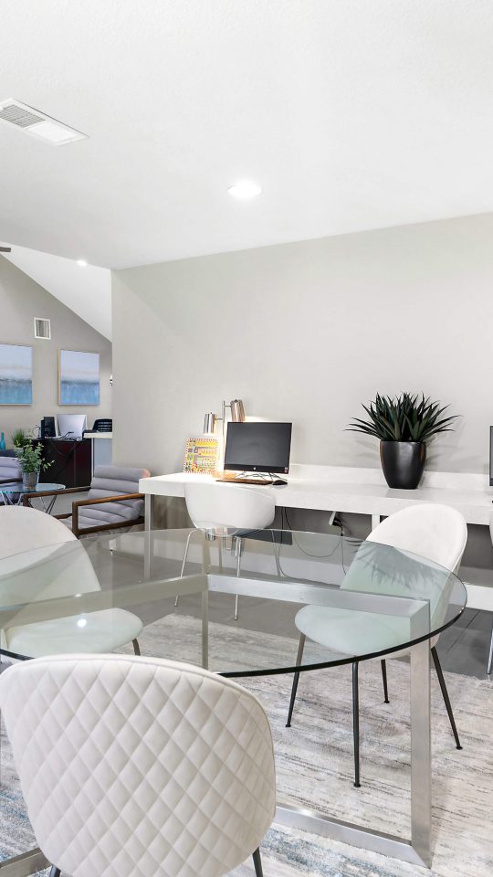 a clean and modern living room with a dining table at The Sonoma Apartments