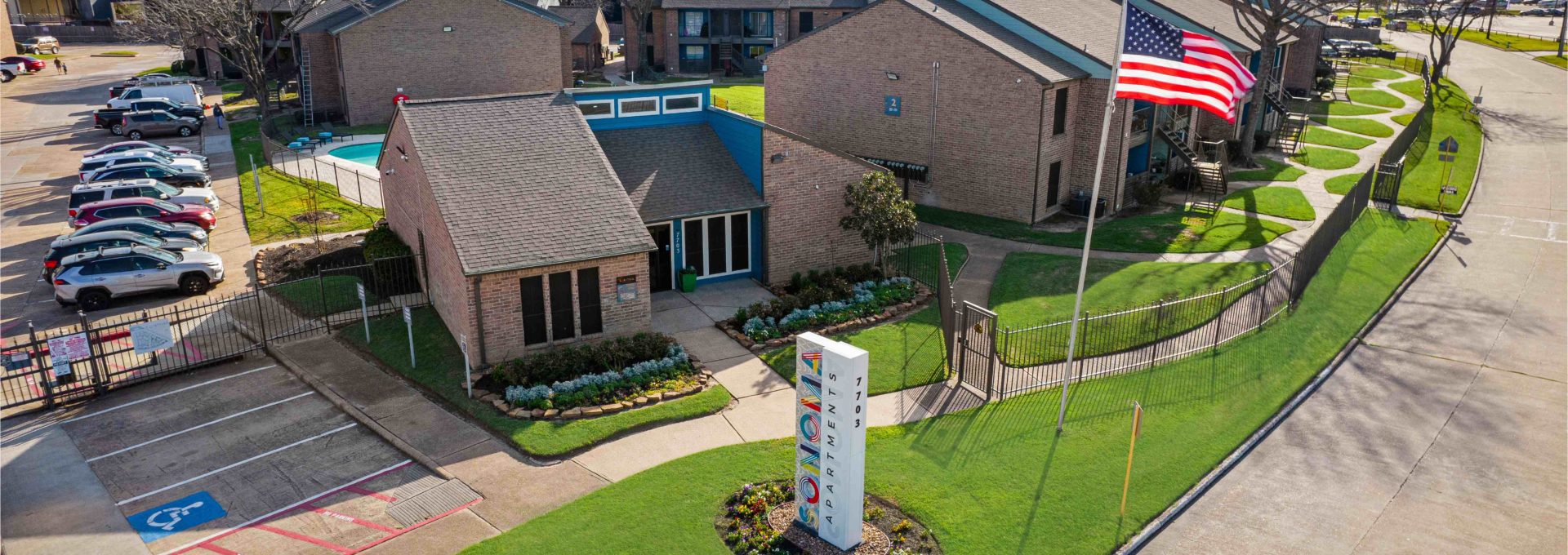 an aerial view of a residential complex with a parking lot at The Sonoma Apartments